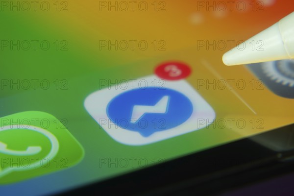16 Nov 2025- Dhaka, Bangladesh: Stylus touching the Facebook Messenger app icon with a notification on a smartphone screen
