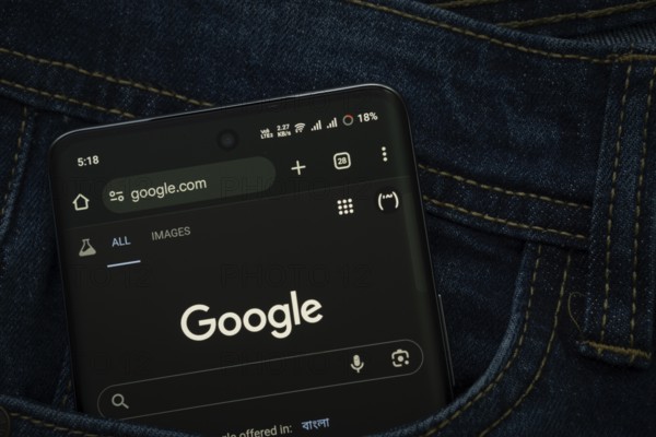 Dhaka, Bangladesh- 15 June 2025: A smartphone displaying the Google web interface peeks out of a denim pocket