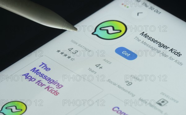 Dhaka, Bangladesh- 30 Oct 2025: Messenger Kids app on a iPad screen with a pen pointing at the install option