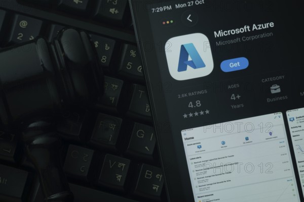 Dhaka, Bangladesh- 28 Oct 2025: An iPad displaying the Microsoft Azure app against a judge's gavel and dark keyboard background