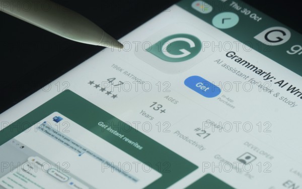 Dhaka, Bangladesh- 30 Oct 2025: Grammarly app on a iPad screen with a pen pointing at the install option