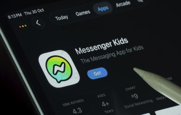 Dhaka, Bangladesh- 30 Oct 2025: Messenger Kids app displayed on a iPad screen in dark mode with a digital pen pointing at it