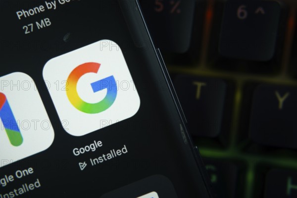 Dhaka, Bangladesh- 27 July 2025: Close-up of smartphone screen showing the Google app icon with a dark interface