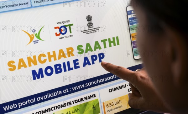 In this photo illustration, a person downloads the Sanchar Saathi mobile application on an iPhone, in New Delhi, India on 3 December 2025. Sanchar Saathi is officially developed and operated by the Department of Telecommunications (DoT), Government of India as part of its citizen-protection and telecom-security initiative