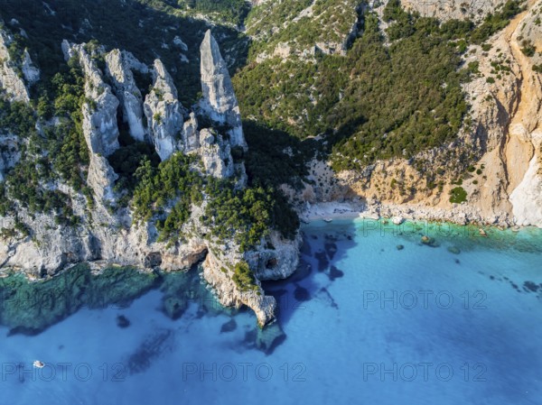 Picturesque rocky coast, cliffs with L'Aguglia pinnacle, blue sea and Cala Goloritzé beach, aerial view, Golfo di Orosei, Baunei, Sardinia, Italy