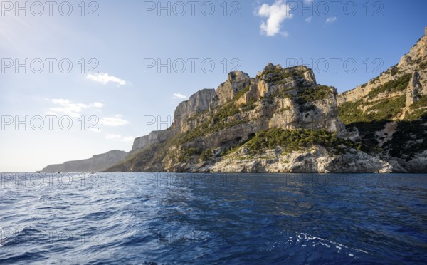 Picturesque rocky coast, cliffs in morning light, blue sea, Golfo di Orosei, Baunei, Sardinia, Italy