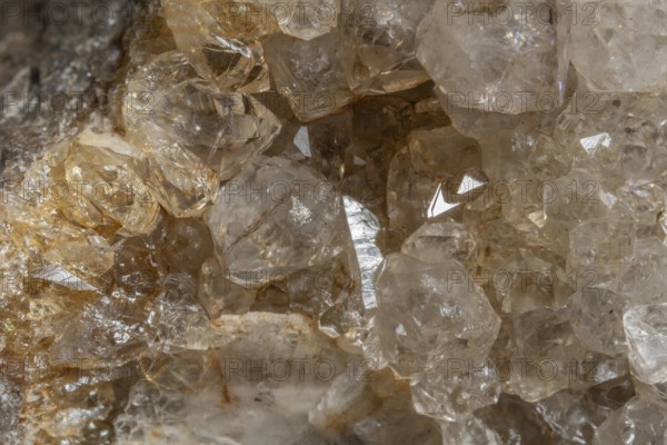 Bright, square crystals are visible on a piece of rock. The light underlines their structure and color. This mineral formation is fascinating and fascinating