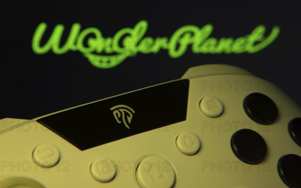 Dhaka, Bangladesh- 14 Nov 2025: A close-up of a gamepad with the WonderPlanet Inc seen on screen in the background