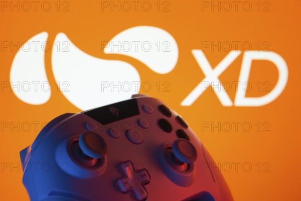 Dhaka, Bangladesh- 14 Nov 2025: A close-up of a gamepad with the XD seen on screen in the background