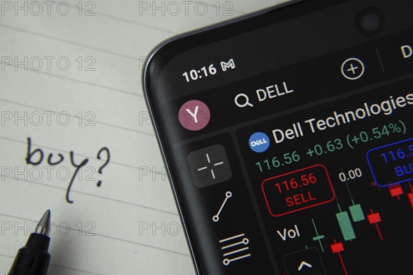 Dhaka, Bangladesh- 20 June 2025: Dell technologies stock trading details displayed on smartphone with handwritten note