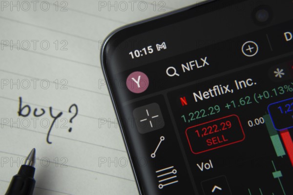 Dhaka, Bangladesh- 20 June 2025: Netflix Inc stock trading details displayed on smartphone with handwritten note