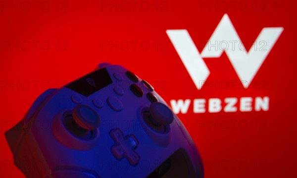 Dhaka, Bangladesh- 14 Nov 2025: A close-up of a gamepad with the Webzen seen on screen in the background