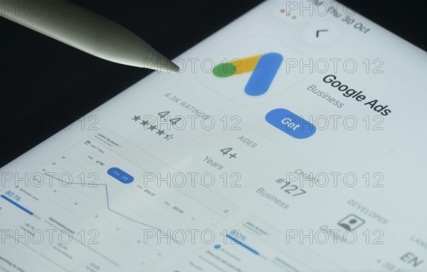 Dhaka, Bangladesh- 30 Oct 2025: Google Ads app on a iPad screen with a pen pointing at the install option