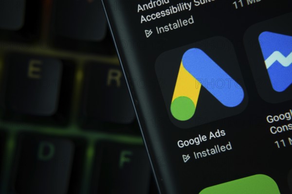 Dhaka, Bangladesh- 27 July 2025: Close-up of smartphone screen showing the Google Ads app icon with a dark interface