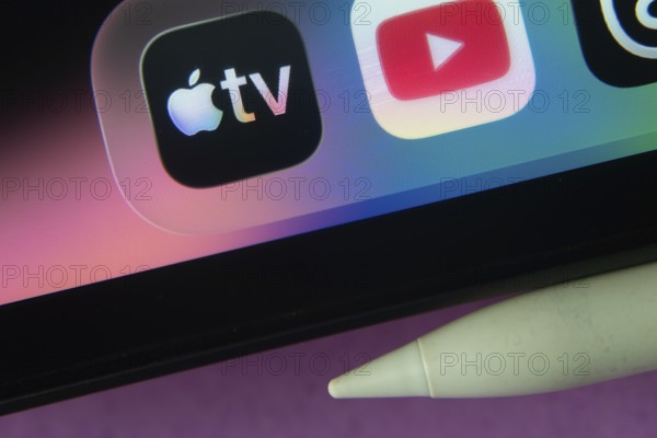 16 Nov 2025- Dhaka, Bangladesh: Apple TV and other app icons with a digital pen on a iPad screen