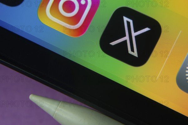 16 Nov 2025- Dhaka, Bangladesh: X and other app icons with a digital pen on a iPad screen