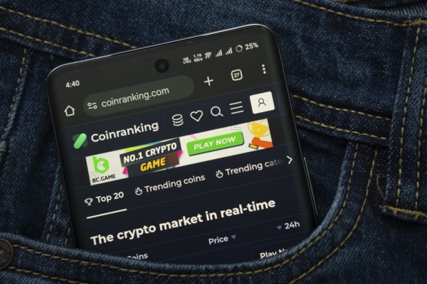 Dhaka, Bangladesh- 15 June 2025: A smartphone displaying the Coinranking web interface peeks out of a denim pocket