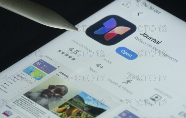 Dhaka, Bangladesh- 30 Oct 2025: Apple Journal app on a iPad screen with a pen pointing at the install option