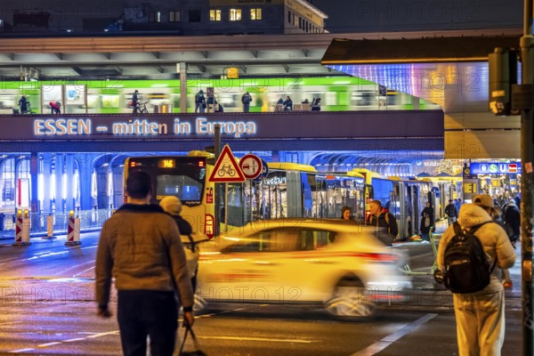 The main train station in Essen, blue illuminated underpass, bus station, am Europaplatz, train on the platform, pedestrian crossing, North Rhine-Westphalia, Germany