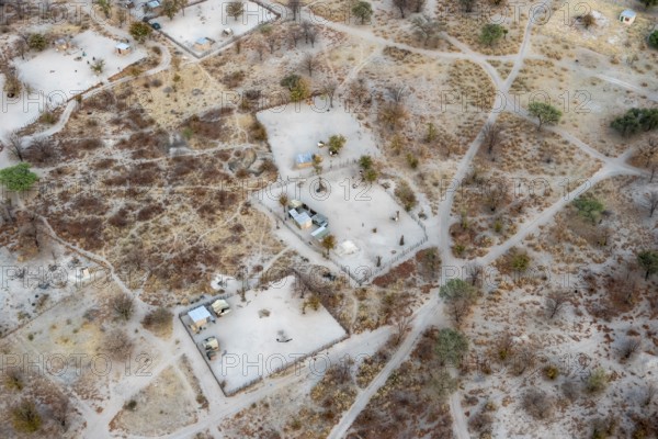 Settlement, simple house and fence, dry savanna landscape, near Maun, aerial view, Okavango Delta, Botswana