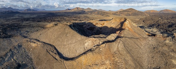 Volcán de Las Nueces volcano, picturesque volcanic landscape with volcanic craters and lava fields in morning light, Parque Natural de Los Volcanes, aerial view, Lanzarote, Canary Islands, Spain