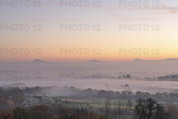 Three Kaiserberge mountains in golden morning light, Hohenstaufen, Aichelberg. Spectacular dawn over the foggy foothills of Baden-Württemberg