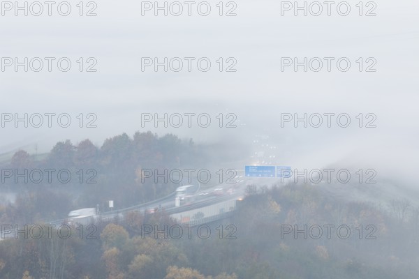 Aichelberg Alb climb of the A8 in thick fog on an autumn morning. Lkr. Göppingen, Baden-Württemberg, Germany