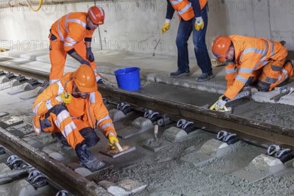 Deutsche Bahn AG track construction at Stuttgart Airport. The last few meters of solid road in the airport tunnel are concreted. This means that all long-distance railway tracks of Project S21 have been laid. Workers lay the rails and concrete the track bed. Stuttgart, Baden-Württemberg, Germany
