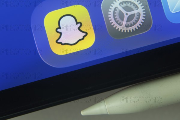 16 Nov 2025- Dhaka, Bangladesh: Snapchat and other app icons with a digital pen on a iPad screen