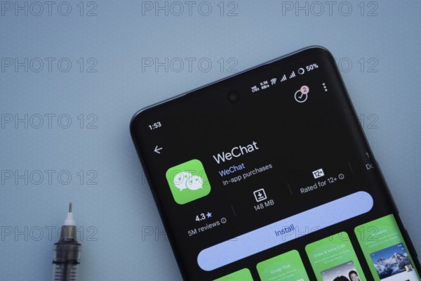 Dhaka, Bangladesh- 29 May 2025: On a blue surface, a smartphone displays the wechat app within the Google Play Store