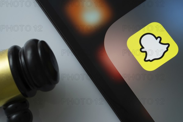 Dhaka, Bangladesh- 17 March 2025: A close up of an iPad screen displaying the Snapchat app alongside a judge's gavel