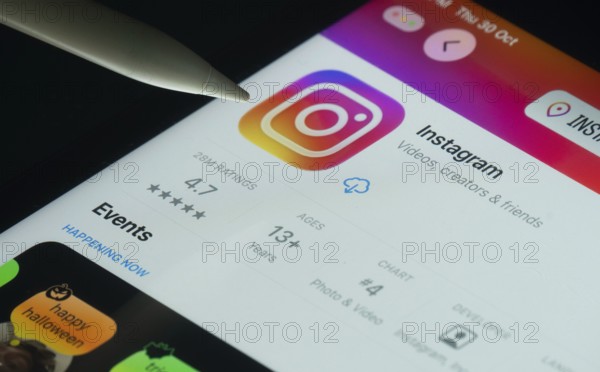 Dhaka, Bangladesh- 30 Oct 2025: Instagram app on a iPad screen with a pen pointing at the install option
