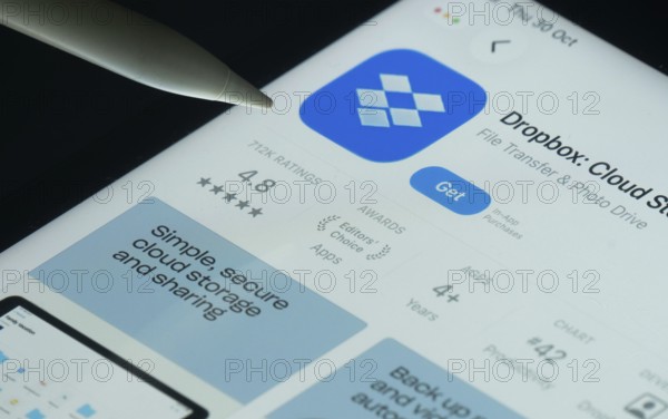 Dhaka, Bangladesh- 30 Oct 2025: Dropbox app on a iPad screen with a pen pointing at the install option