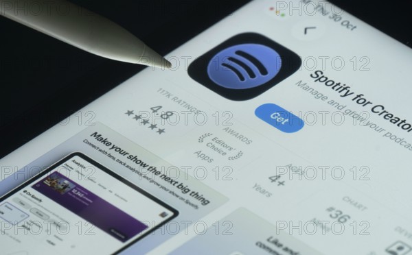 Dhaka, Bangladesh- 30 Oct 2025: Spotify for Creators app on a iPad screen with a pen pointing at the install option