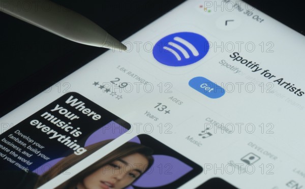 Dhaka, Bangladesh- 30 Oct 2025: Spotify for Artists app on a iPad screen with a pen pointing at the install option