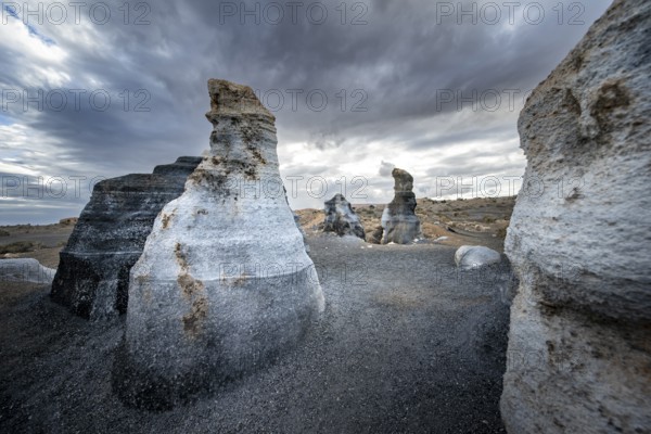 Eroded rock formations, volcanic landscape with dramatic cloudy skies, Ciudad Estratificada or Los Roferos, Antigua Rofera de Teseguite, Lanzarote, Canary Islands, Spain