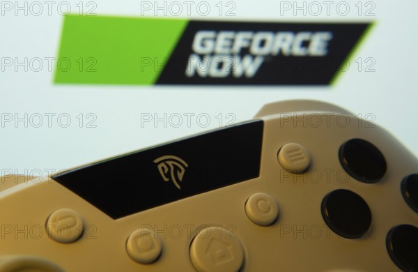 Dhaka, Bangladesh- 14 Nov 2025: A close-up of a gamepad with the Geforce Now seen on screen in the background