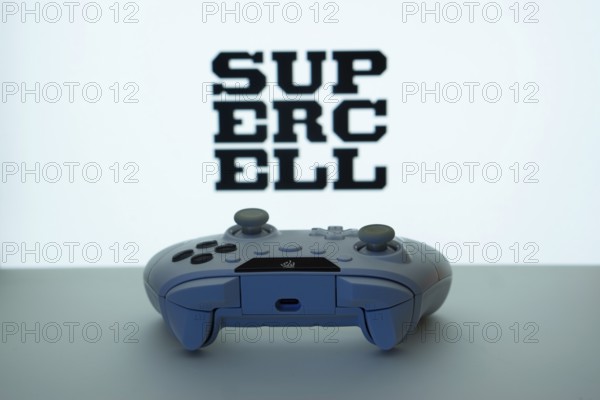 Dhaka, Bangladesh- 14 Nov 2025: A close-up of a white gamepad with the Supercell seen on screen in the background