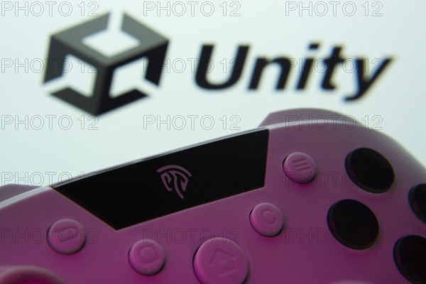 Dhaka, Bangladesh- 14 Nov 2025: A close-up of a gamepad with the Unity seen on screen in the background