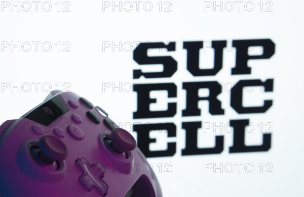 Dhaka, Bangladesh- 14 Nov 2025: A close-up of a gamepad with the Supercell seen on screen in the background