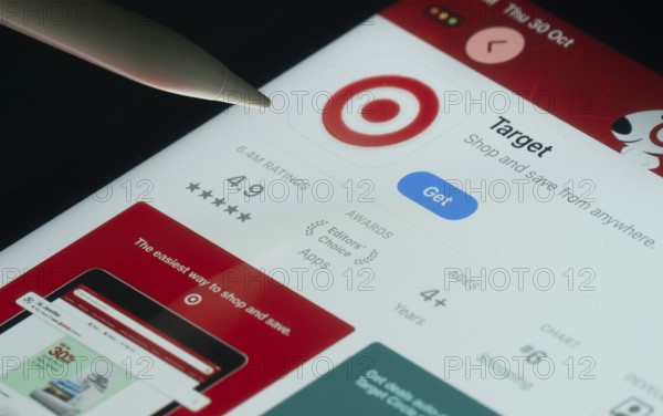 Dhaka, Bangladesh- 30 Oct 2025: Target app on a iPad screen with a pen pointing at the install option