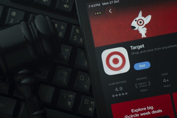 Dhaka, Bangladesh- 28 Oct 2025: An iPad displaying the Target app against a judge's gavel and dark keyboard background