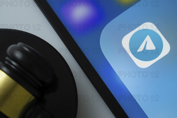 Dhaka, Bangladesh- 09 Feb 2025: A close up of an iPad screen displaying the Telegram app alongside a judge's gavel