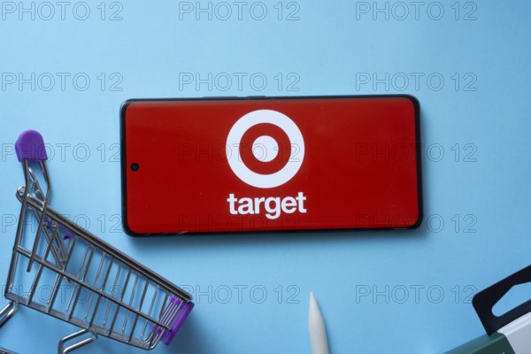 Dhaka, Bangladesh- 03 July 2025: Smartphone displaying Target logo with shopping cart on a blue background