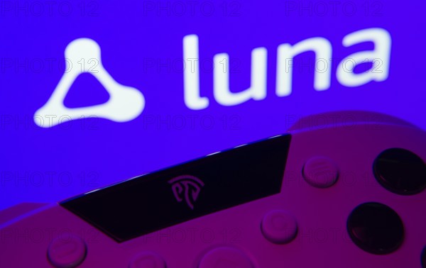 Dhaka, Bangladesh- 14 Nov 2025: A close-up of a gamepad with the Amazon Luna seen on screen in the background