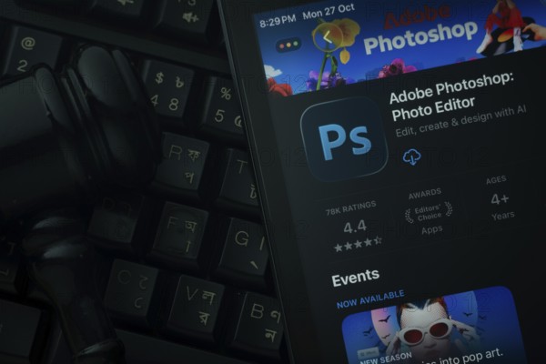 Dhaka, Bangladesh- 28 Oct 2025: An iPad displaying the Adobe Photoshop app against a judge's gavel and dark keyboard background