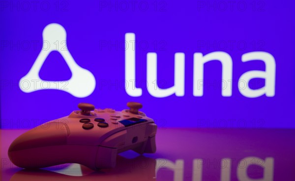 Dhaka, Bangladesh- 14 Nov 2025: A close-up of a white gamepad with the Amazon Luna seen on screen in the background