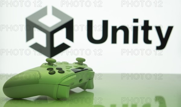 Dhaka, Bangladesh- 14 Nov 2025: A close-up of a white gamepad with the Unity seen on screen in the background