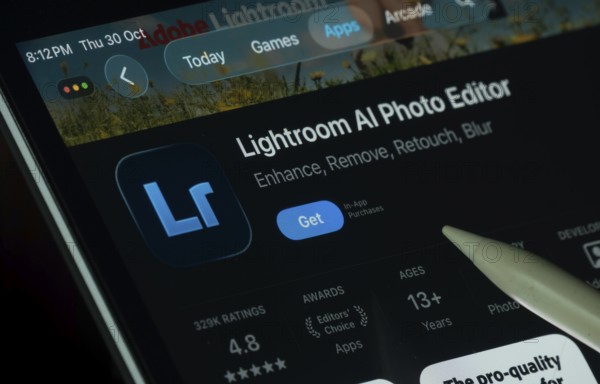 Dhaka, Bangladesh- 30 Oct 2025: Lightroom Ai app displayed on a iPad screen in dark mode with a digital pen pointing at it