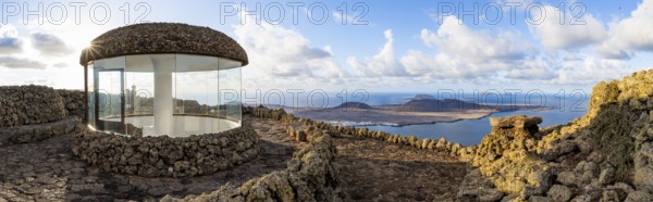 Stairway and viewing platform at the Mirador del Río viewpoint, in the evening light with sun stars, designed by artist César Manrique, view of the island of La Graciosa, Lanzarote, Canary Islands, Spain